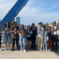 Group of students near blue bridge with funny faces